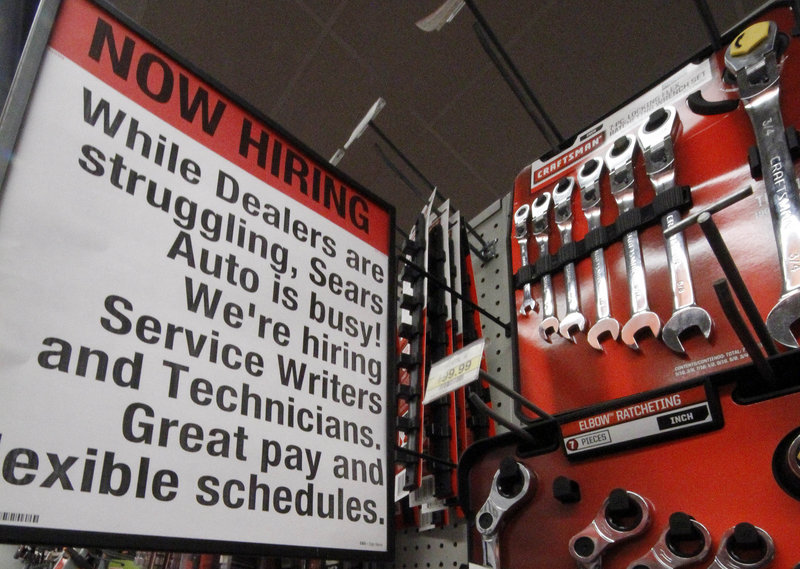 A “Now Hiring” sign is posted near a display of wrenches at a Sears store in Bethel Park, Pa. The jobless rate fell last month in more than three-quarters of the nation’s states, with companies feeling more confident in the U.S. economy.