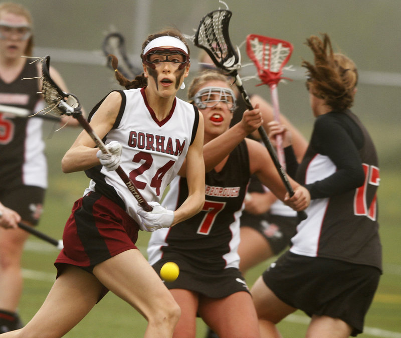Mia Rapolla of Gorham, left, and Scarborough s Kat Gadbois go after a loose ball Friday night during Scarborough s 13-9 girls lacrosse win.