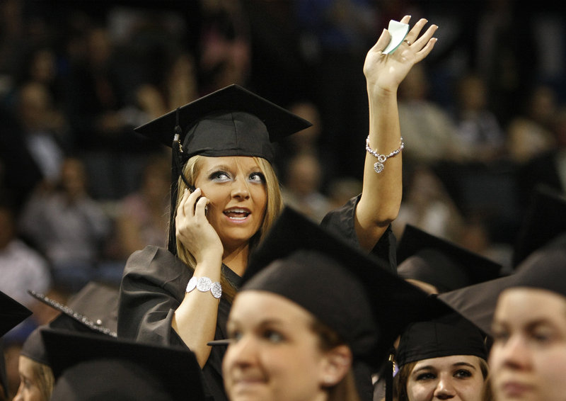 Audrey Grass of Sabattus looks for friends and family before the start of the University of New England's commencement at the Cumberland County Civic Center in Portland on Saturday. Grass received her degree in occupational therapy.