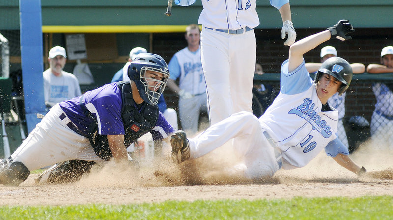 Joe Quinlan of Westbrook slides past a tag applied by Deering catcher John Miranda to score on a steal of home during the fourth inning of unbeaten Westbrook's 6-0 victory Saturday at Hadlock Field.