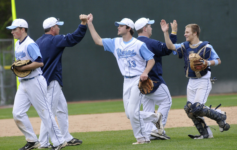 Westbrook pitcher Scott Heath, center, and his brother, catcher Kyle Heath, celebrate after the final out Saturday as the unbeaten Blue Blazes downed Deering 6-0 at Hadlock Field.