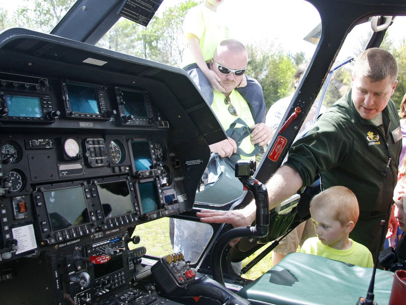Pilot Scott Blake shows Ezekiel Lyons, 4, of Rochester, N.H., the cockpit of LifeFlight 2.