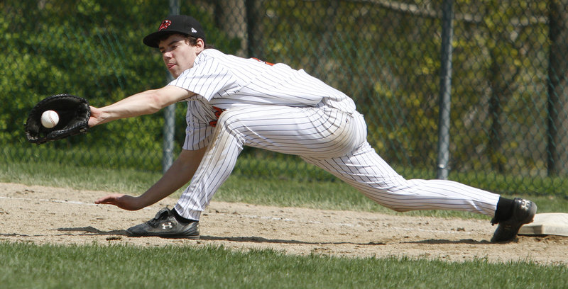 Ryan Salerno, the first baseman for North Yarmouth Academy, keeps his foot on the base and makes the stretch to record a second-inning out in the second game of the doubleheader against Waynflete.