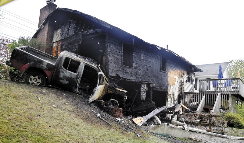 A pickup truck burst into flames Sunday after striking the home of Ken and Linda Ward on Riverside Drive in Augusta. Both the homeowners and the truck operator managed to flee the fire that destroyed the home and pickup.