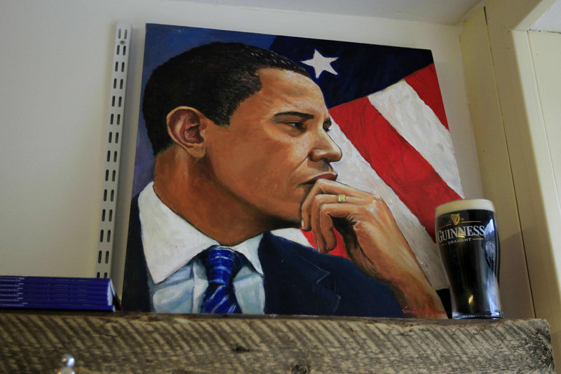 A painting of President Obama stands next to a replica pint of Guinness in a shop in Moneygall, Ireland, on Saturday. As part of his visit, Obama is expected to stop at a pub in Moneygall, the ancestral homeland of his great-great-great-grandfather.