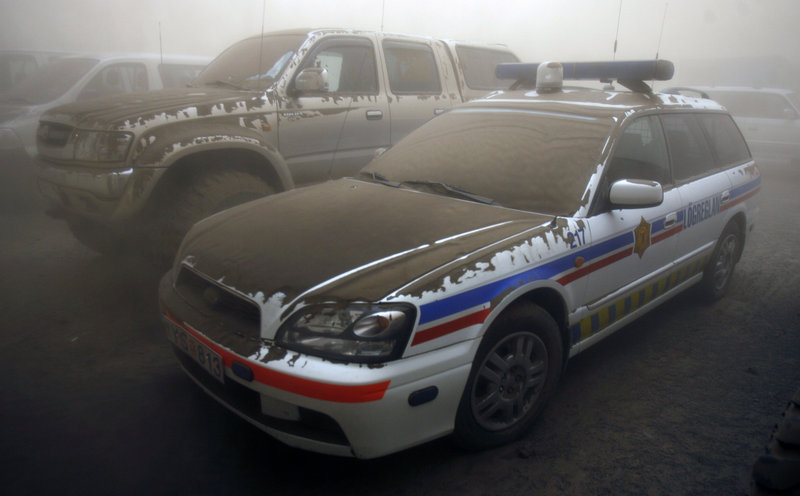 Vehicles are covered in ash near Kirkjubaearklaustur. Officials say the ash cloud will reach Scotland by today.