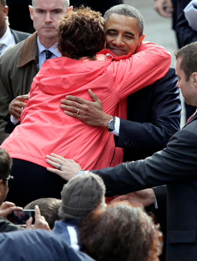 President Obama is hugged by a well-wisher after speaking Monday at College Green in Dublin, Ireland.