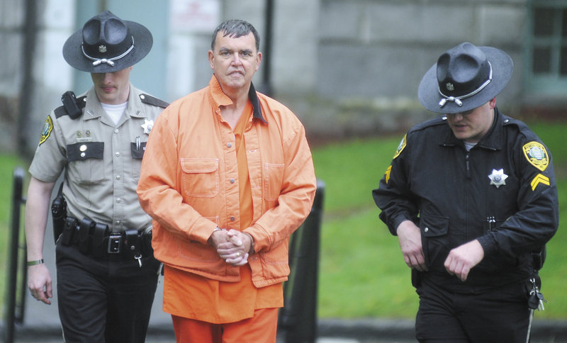 Rep. Fred Wintle is escorted at Kennebec County Superior Court on Monday.