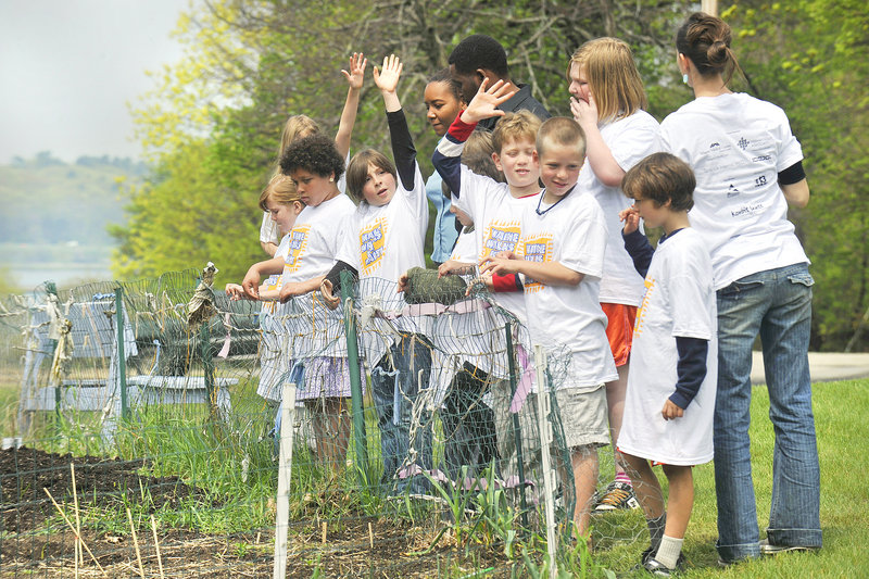Fourth-grade students at the Friends School of Portland and their teacher show their school’s garden to their Haitian visitors during a tour May 24. The “Maine Walks for Haiti” fundraiser will be held Saturday around Back Cove.