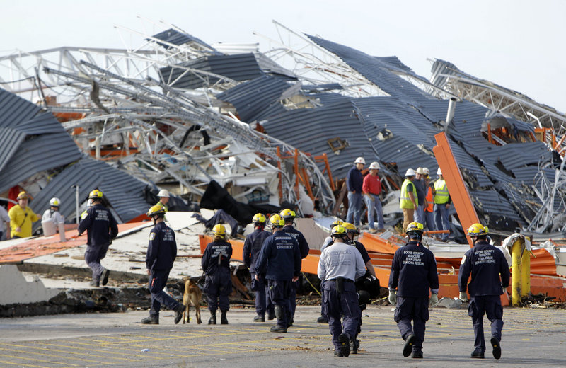 Members of the Missouri Task Force One search-and-rescue team work at a tornado-damaged Home Depot store Tuesday in Joplin, Mo. A day earlier, rescuers found one person alive in the store's wreckage but also recovered seven bodies under the concrete.