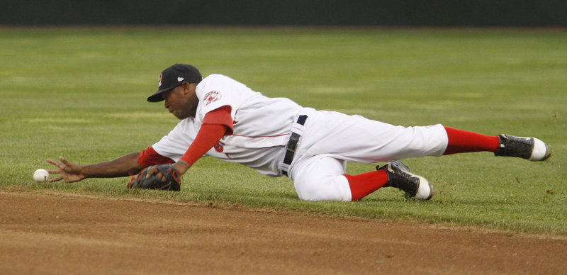 Sea Dogs second baseman Oscar Tejeda tries to barehand a ball that deflected of the glove of first baseman Jorge Padron during Portland's 8-3 loss to New Hampshire.