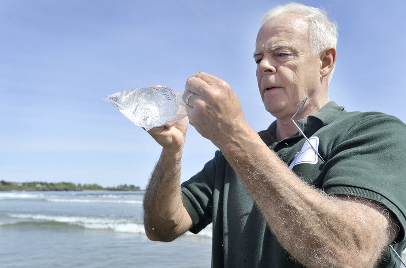 Scarborough resident Bill Donovan seals a water sample in a plastic bag during training on Wednesday. By the end of June, nearly 200 volunteer monitors will be trained.