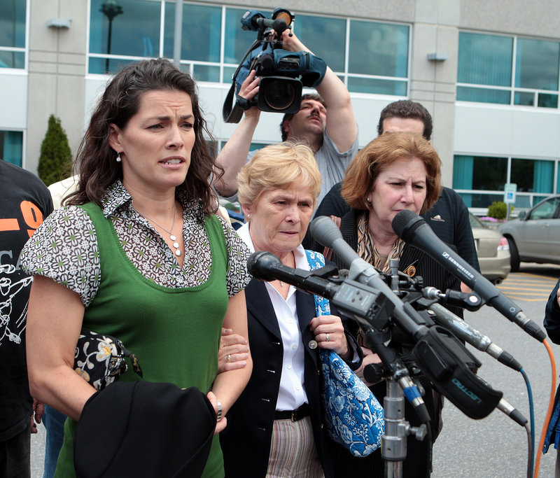Former Olympic skater Nancy Kerrigan, left, makes a statement as her mother, Brenda, center, and attorney Janice Bassil, right, leave the courthouse Wednesday after Mark Kerrigan was acquitted of manslaughter in Middlesex Superior Court in Woburn, Mass.