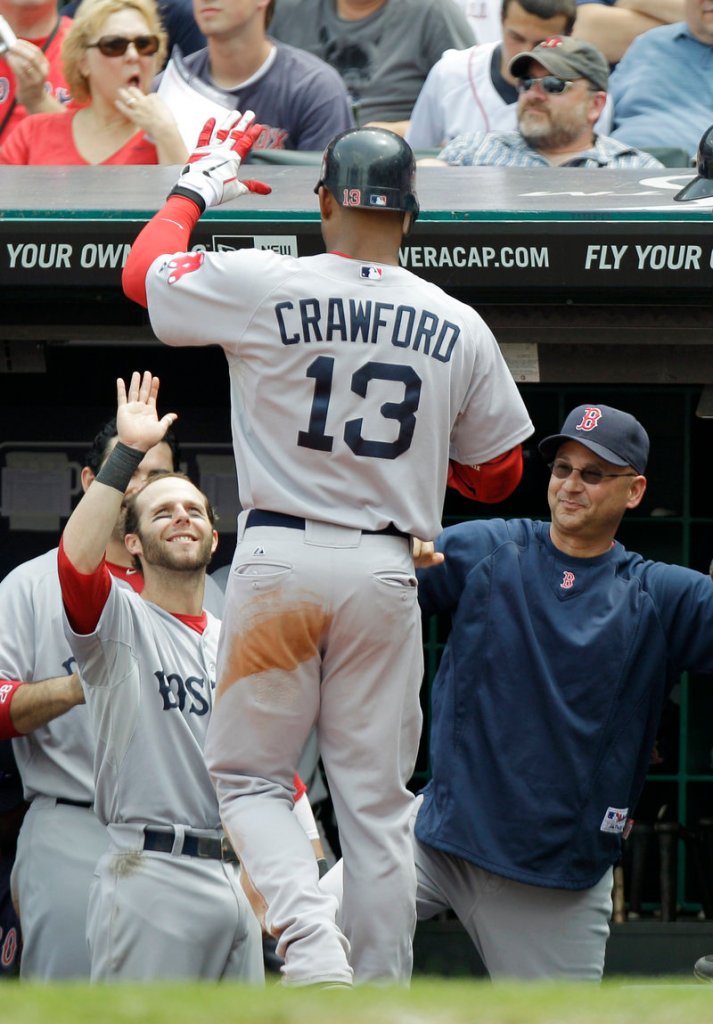 Carl Crawford, greeted by Dustin Pedroia, left, and Manager Terry Francona after hitting a solo home run in the fourth inning Wednesday, finally is coming around for the Boston Red Sox. He went 4 for 4 with two doubles, three runs and two RBI, and was 6 of 11 in the series against the Cleveland Indians.