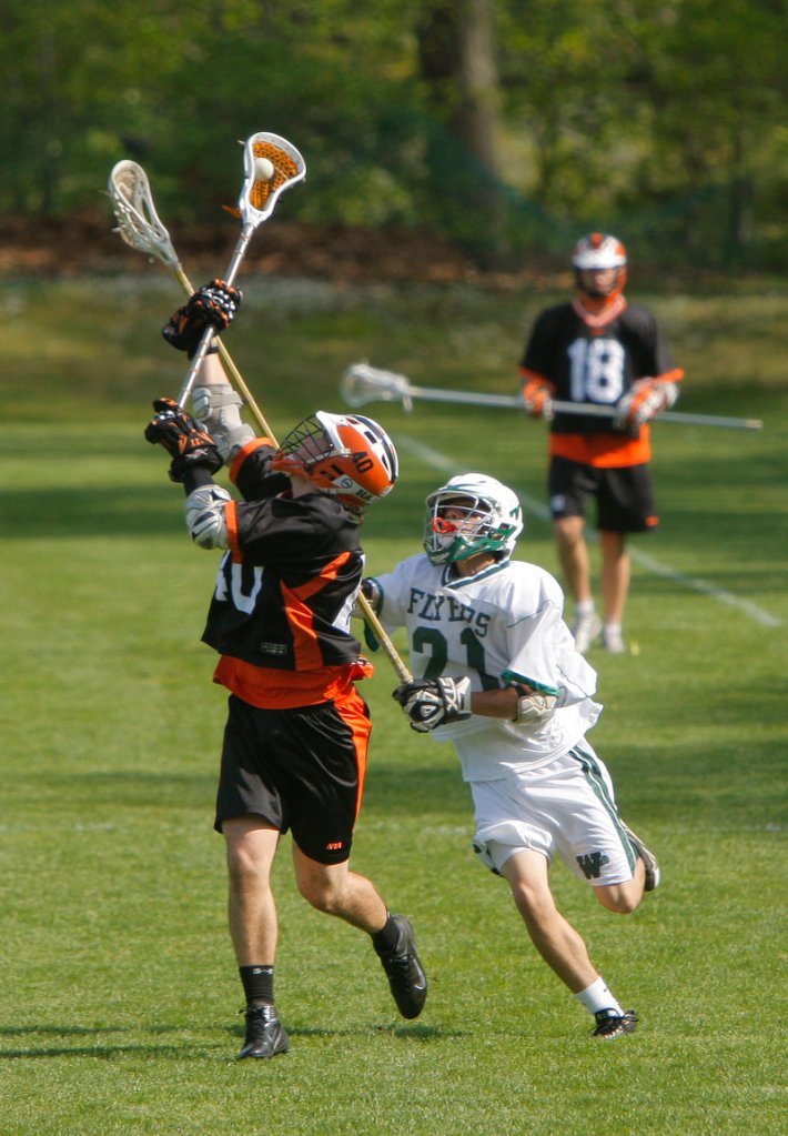 Finn Hadlock of North Yarmouth Academy hauls in a long pass Wednesday while defended by Forrest Chap of Waynflete during Waynflete s 11-7 victory at home in schoolboy lacrosse.