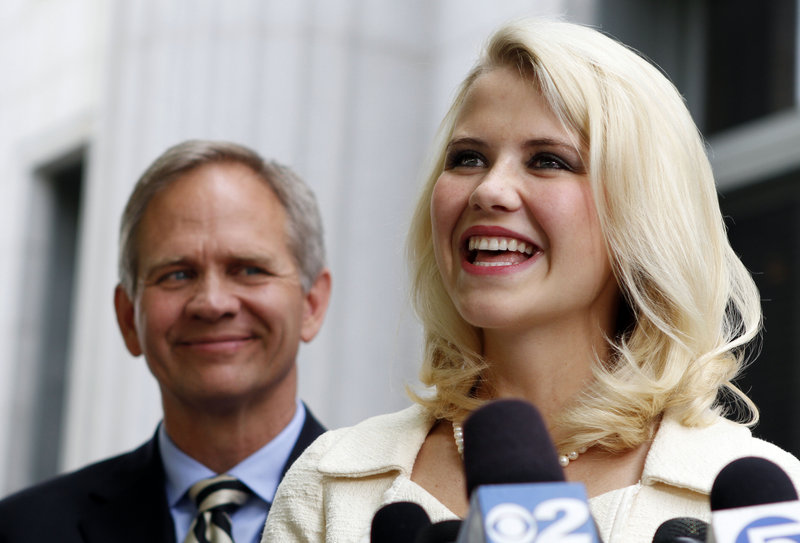Elizabeth Smart and her father, Ed Smart, talk to the media Wednesday in Salt Lake City. She said the sentencing marks the end of a long chapter in her life – and a new beginning.