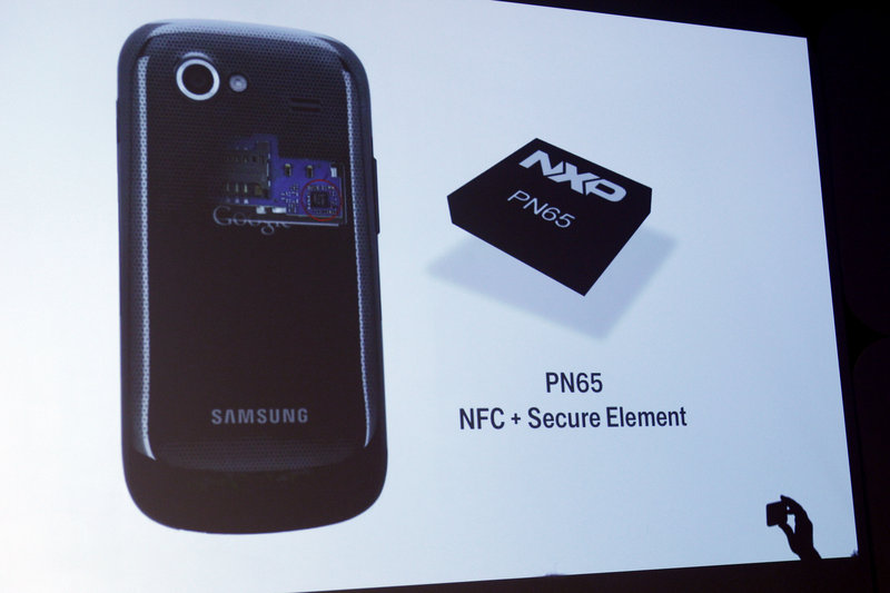 A security chip is displayed on a screen during the presentation.