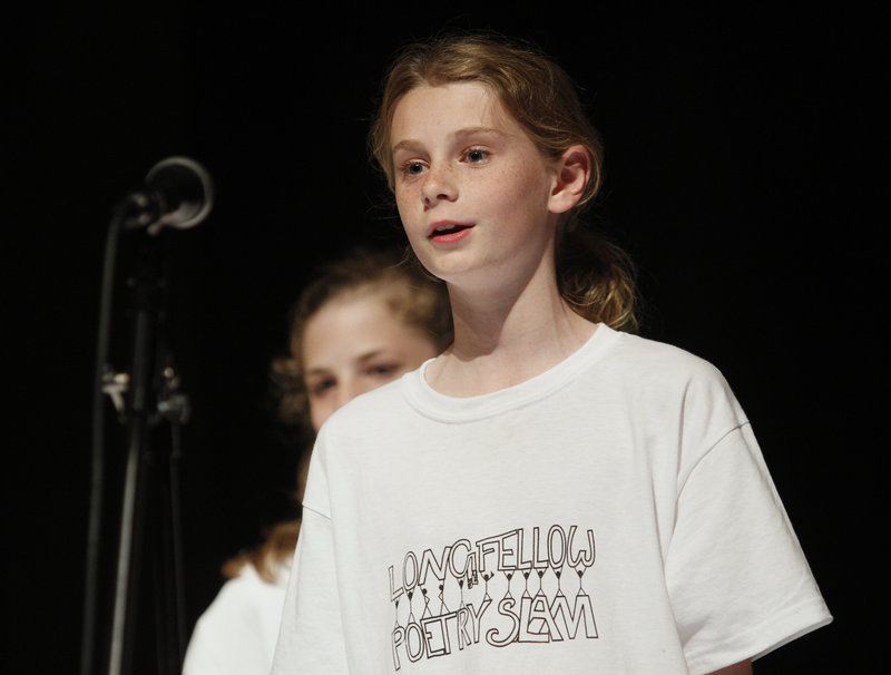 Gracie LaGrange of Shock’em performs the team’s poem “I Know” during the first round of the poetry slam Thursday night. More than 50 fifth-graders from Longfellow Elementary School participated.