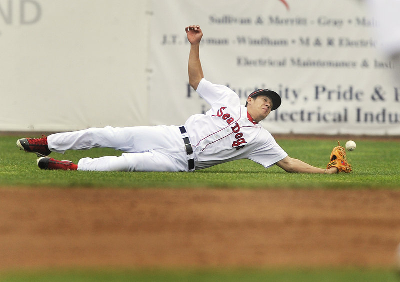 Right fielder Chih-Hsien Chiang of the Portland Sea Dogs just misses coming up with a shallow fly ball Thursday night during the 13-7 loss to the New Hampshire Fisher Cats.