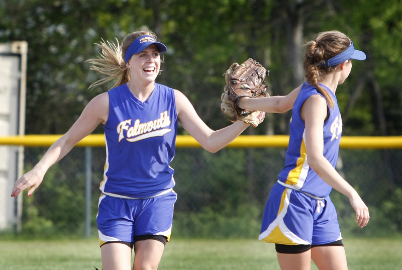Left fielder Sarah Sparks, left, is congratulated by shortstop Jessie L Heureux of Falmouth after hauling down a high fly ball in the fourth inning Friday during a 3-1 victory against Sacopee Valley in a Western Maine Conference softball game at Falmouth.