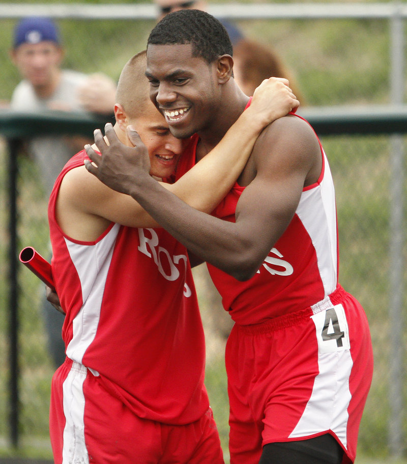 Teddy LeFay, left, and Adrian Reid of South Portland celebrate Saturday after helping the Red Riots win the 400-meter relay in the SMAA meet at Scarborough.