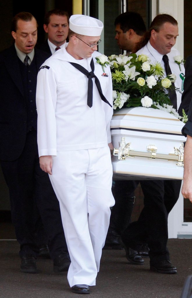 Ian McCrery, dressed in his Navy uniform, assists in carrying the casket for his younger brother, Camden Hughes at Saturday’s memorial service.