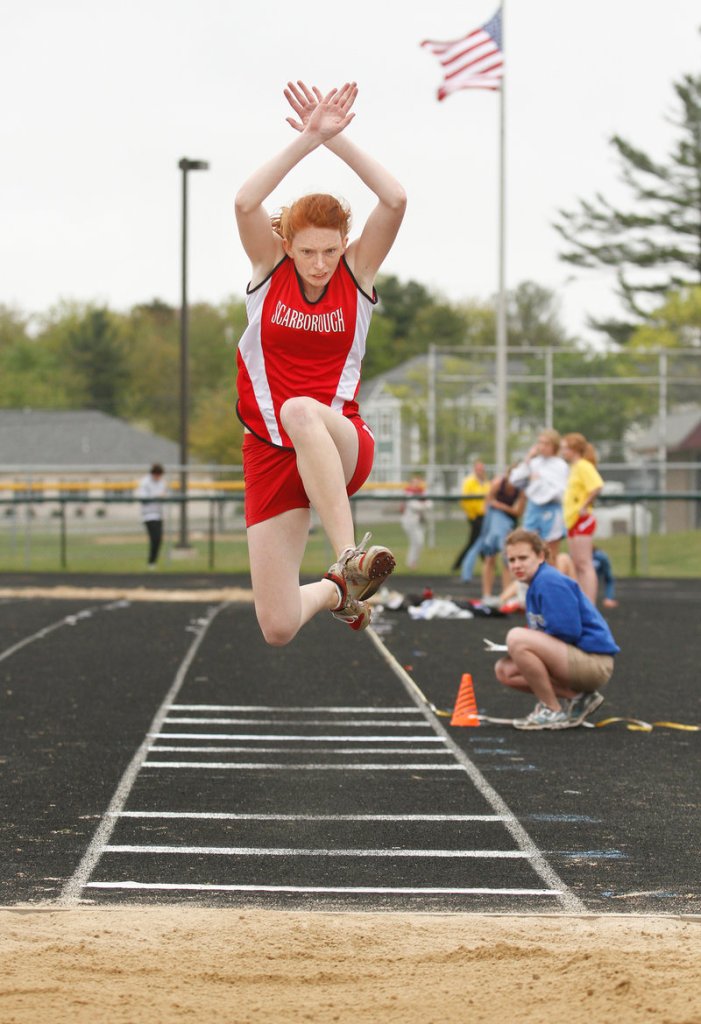 Emilia Scheemaker of Scarborough looks for a perfect landing while competing in the triple jump.