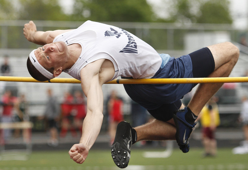 Zach Dugas of Westbrook stretches Saturday in an attempt to clear 6 feet in the high jump during the SMAA meet at Scarborough. Dugas placed third at 5-10. Malcolm Smith of Cheverus captured the event with a leap of 6 feet.