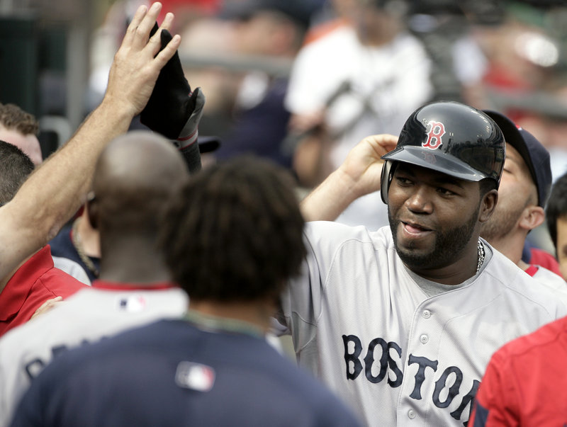David Ortiz is congratulated by teammates after hitting a pinch-hit home run in the top of the ninth inning Sunday to help the Red Sox take a 4-3 win in the first game.