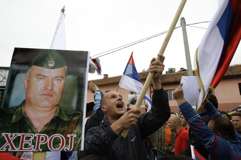 Demonstrators wave Serbian flags and hold photos of former Gen. Ratko Mladic in Kalinovik, Bosnia, hometown of the Bosnian Serb wartime military leader, on Sunday.