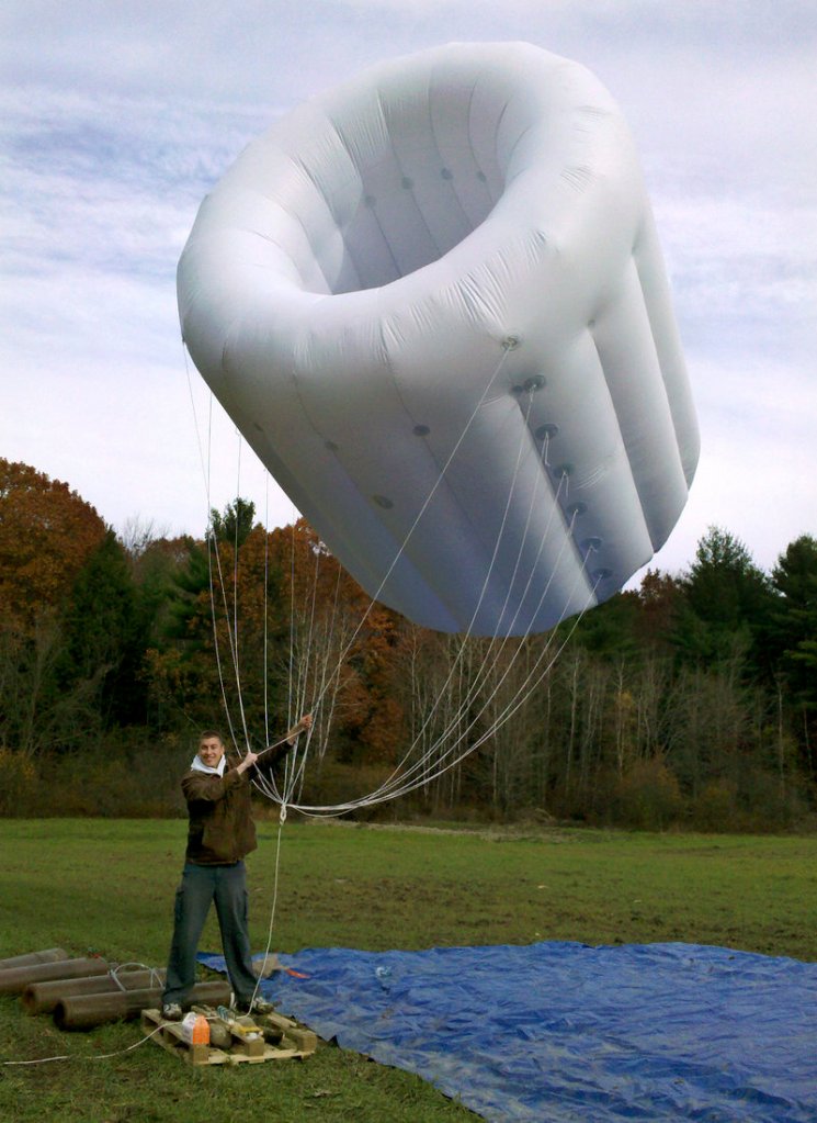 This November 2010 photo show Altaeros Energies’ Adam Rein with a prototype airborne power turbine shroud in Amesbury, Mass.