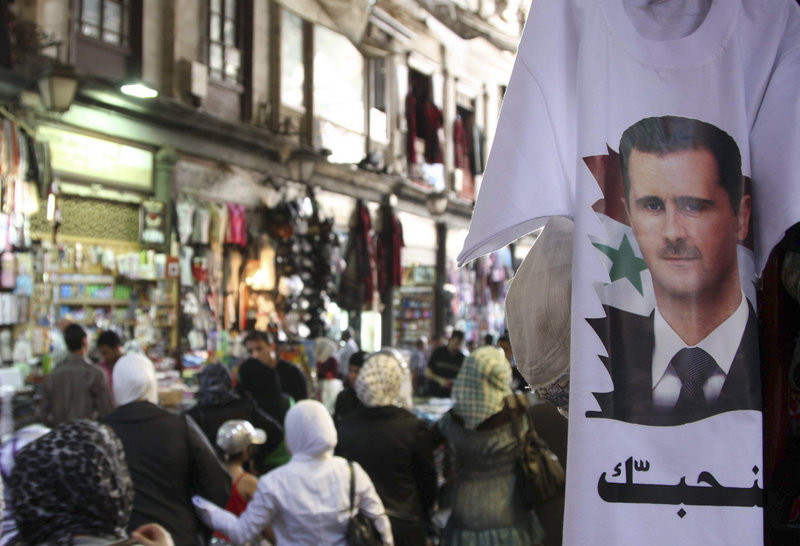 Syrian President Bashar Assad’s image adorns a T-shirt in Damascus on Monday. What began as a disparate movement demanding reforms has erupted into a resilient uprising for his ouster. Rights groups say more than 1,000 people have been killed in the crackdown.