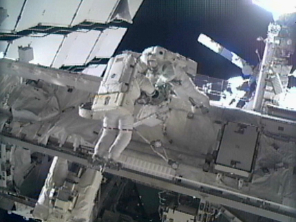 Astronauts Greg Chamitoff and Mike Fincke work on the exterior of the International Space Station during the fourth spacewalk of the STS-134 mission.