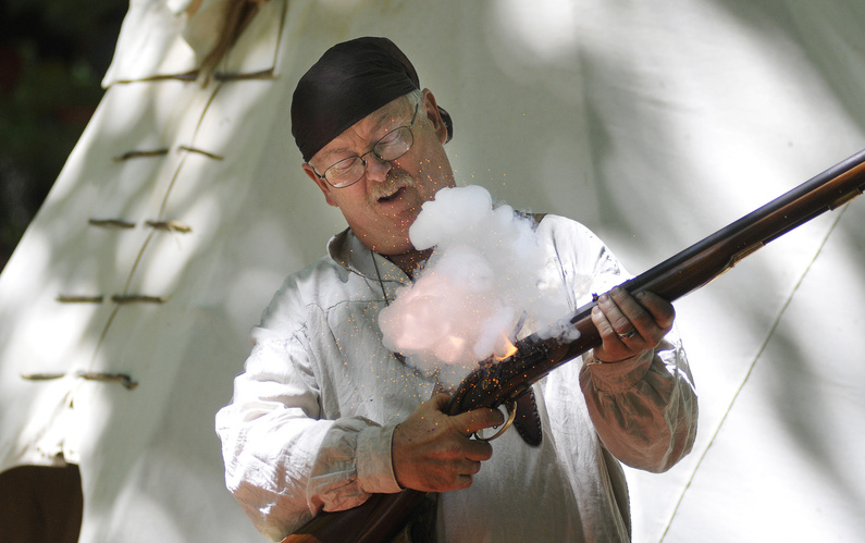 Ray Hamilton of Livermore demonstrates a “flash in the pan” with a 1776 British flintlock musket. The term refers to gunpowder flaring up without a bullet being fired.