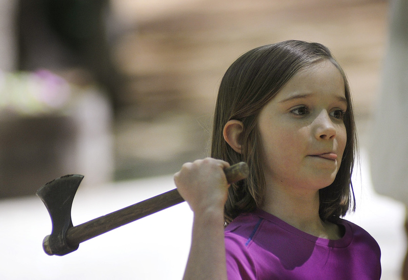 Alex Bunker, 8, of Brunswick concentrates as she tries her hand at throwing a tomahawk.