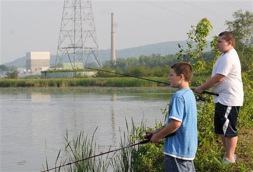 In this May 29, 2010 file photo, Shawn Cole, 12, of Hinsdale, N.H., left, and Peter Rosploch, 11, of Winchester, N.H. fish in the Connecticut River across from the Vermont Yankee nuclear power plant. In 2010, the Vermont Senate was so troubled by tritium leaks as high as 2.5 million picocuries per liter at the Vermont Yankee reactor in southern Vermont (125 times the EPA drinking-water standard) that it voted to block relicensing _ a power that the Legislature holds in that state. But in March 2011, the NRC granted the plant a 20-year license extension, despite the state opposition. Afterwards, operator Entergy sued Vermont in federal court, challenging its authority to force the plant to close. (AP Photo/Jason R. Henske)