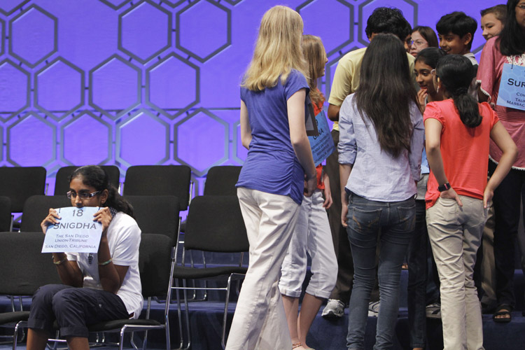Snigdha Nandipati, 13, from San Diego, Calif., left, continues to concentrate as other spellers chat during a break in competition during the semifinals of the National Spelling Bee today.