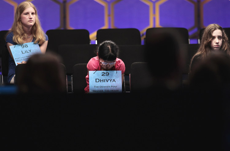 From left to right, Lily Jordan, 14, of Cape Elizabeth, Dhivya Senthil Murugan, 10, from Denver, Colo., and Veronica I. Penny, 13, from Ottawa, Canada sit through the end of the semifinals of the 2011 Scripps National Spelling Bee today.