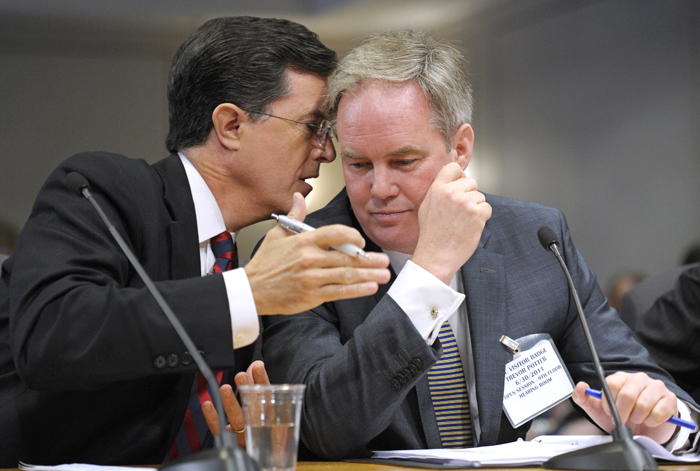 Comedian Stephen Colbert, left, confers with his attorney Trevor Potter, as he testifies before the Federal Election Commission in Washington today.
