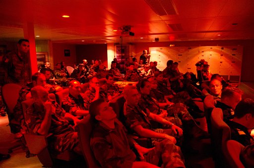 In this photo provided by the French Army, aircrew members are briefed aboard the French navy vessel BPC Tonnerre in the Mediterranean sea today. British Apache and French attack helicopters struck targets for the first time in NATO's campaign in Libya, hitting Moammar Gadhafi's troops near a key coastal oil town, the alliance said. Hours later, at least eight airstrikes were heard in Tripoli.