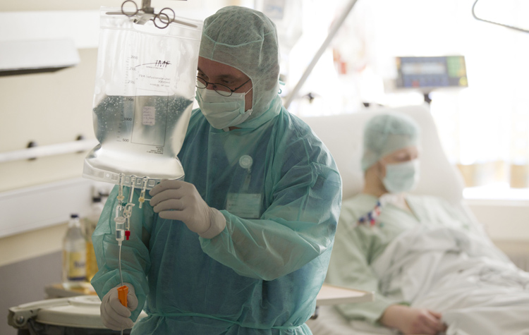 Doctor Hauke Weilert checks the infusion of an E. coli patient undergoing a kidney dialysis at Asklepios Hospital in Hamburg-Altona, Germany, on Monday. Doctors at the Asklepios Hospital started to treat their E. coli patients with unorthodox therapies including antibiotics and antibodies, despite warnings by WHO and the German government.