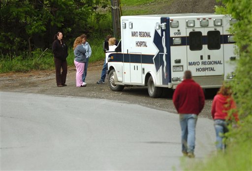 Family members gather on Shore Road at a police roadblock in Dexter, Maine, Monday, June 13, 2011, awaiting news concerning a domestic incident after five or six shots were heard at a residence by a Dexter police officer who was checking on the well-being of the family after a woman who lives there didn't show up for work and the children didn't arrive at school. (AP Photo/Bangor Daily News, Kate Collins)