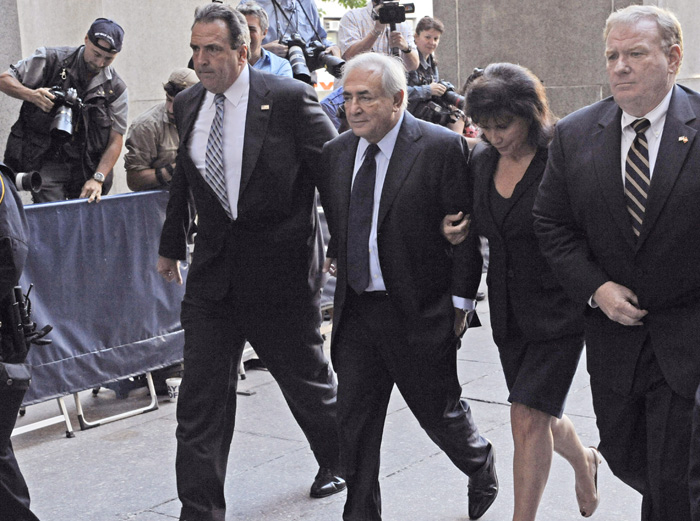 Former International Monetary Fund leader Dominique Strauss-Kahn enters Manhattan criminal court with his wife Anne Sinclair today for his arraignment proceedings on charges of sexually assaulting a hotel maid.