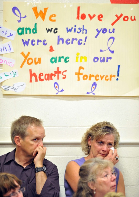 Signs of love and support decorate the walls of the Dexter Regional High School gymnasium during the funeral for Amy, Coty and Monica Lake in Dexter on Saturday.