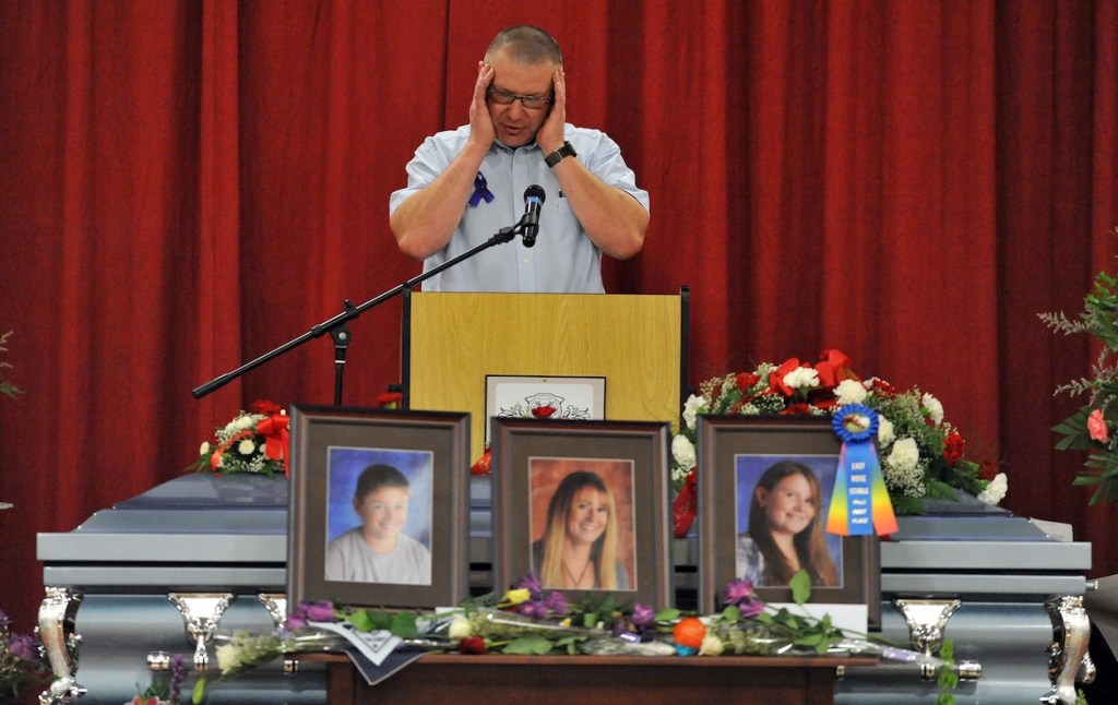 Ron Bagley, cousin of Amy Lake, speaks during funeral services for Amy, Coty and Monica Lake at Dexter Regional High School in Dexter, Saturday, June 18, 2011.