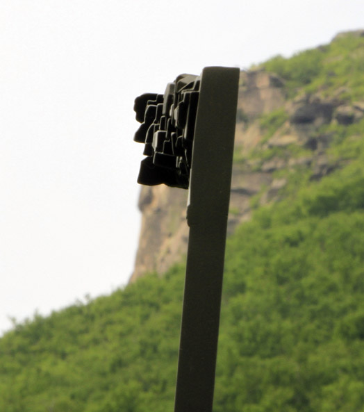One of seven sculptures of the Old Man line up with the position the granite formation once occupied on Cannon Mountain.