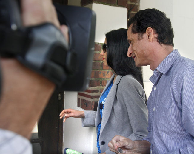 U.S. Rep. Anthony Weiner and his wife, Huma Abedin, arrive at their home in Queens, N.Y., today. He later left alone to go to the news conference where he announced his resignation.