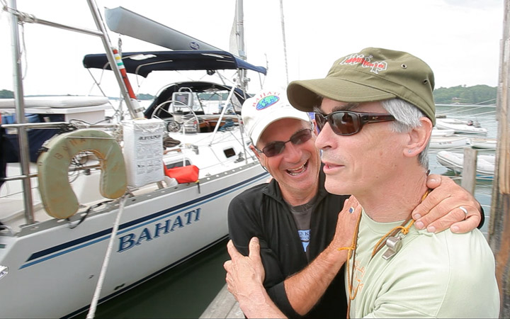Nat Warren-White, left, laughs with friend Sam Kilbourn after Warren-White returned to Freeport from a 4½-year circumnavigation of the globe with his wife Betsy.