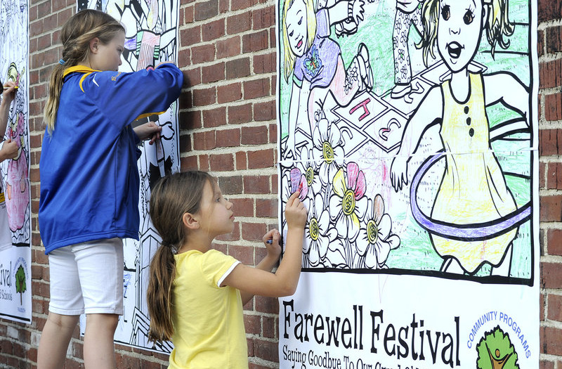 Kylie Sabo, 9, colors a wall mural at the Falmouth Farewell Festival for parents and students at the Plummer-Motz and Lunt elementary schools in Falmouth on Friday.