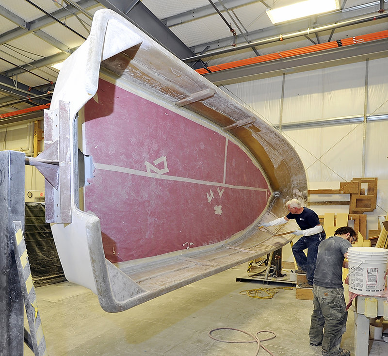 Interior finishers prepare the hull of a Maritime Marine boat at Kenway Corp. in Augusta, which makes fiberglass boats, tanks and pipe. Since 2003, Kenway has purchased two boatbuilding companies.